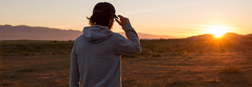 Man outside with drill working on a home improvement project.
